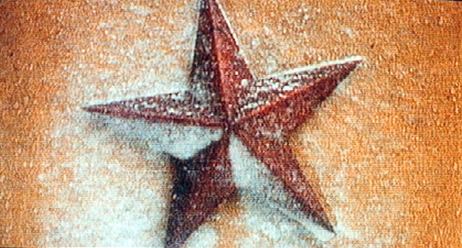 A red star painted on a pale wall